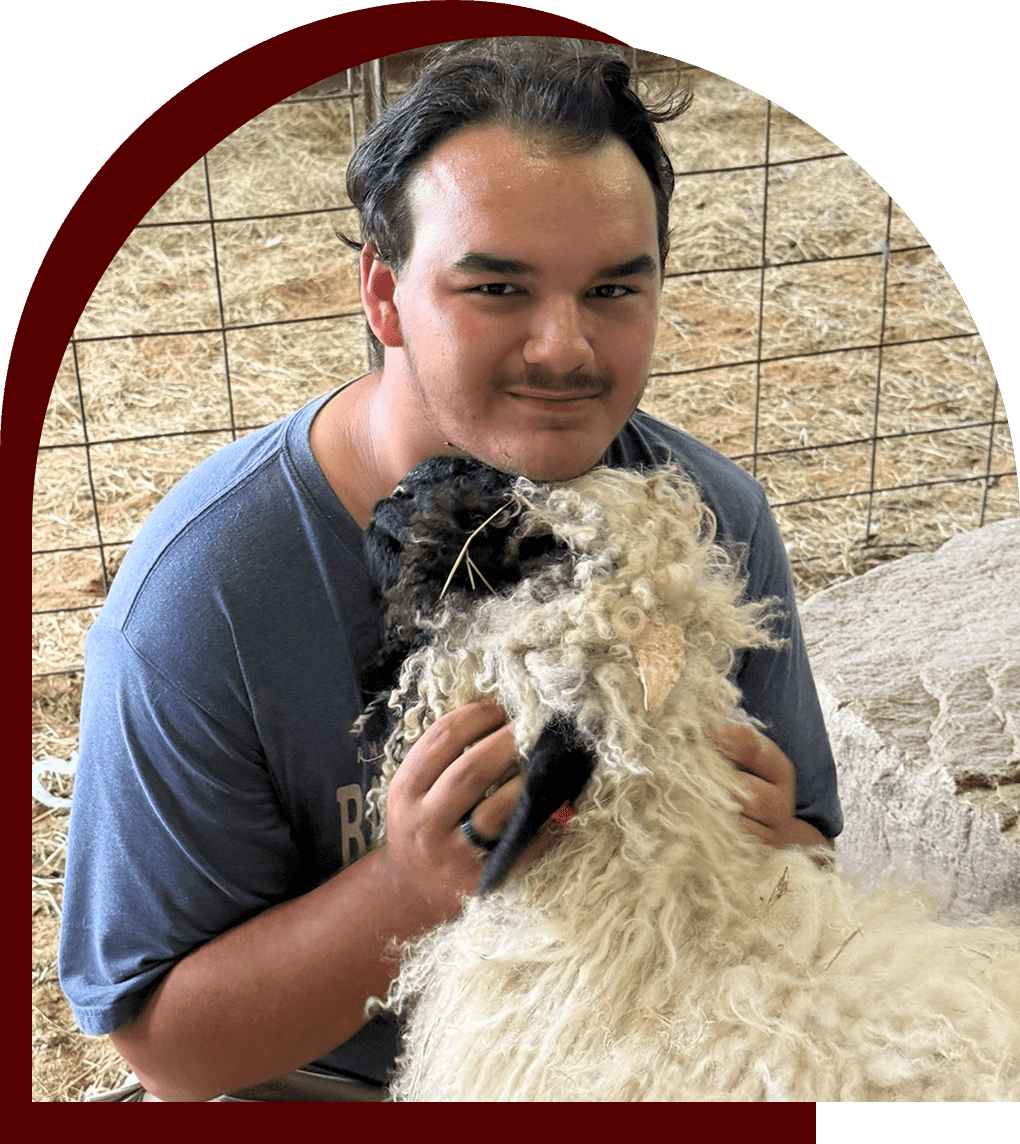 Person smiling with a fluffy dog indoors.