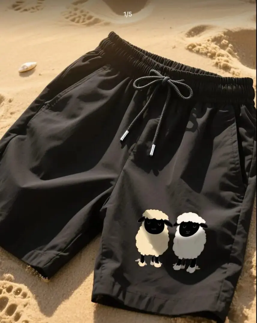 Black shorts with two cartoon penguins wearing sunglasses.